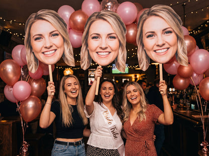 Big head cut-outs on sticks at a hen party (example design)