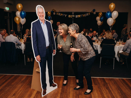 Life-size cut-out of a man in a suit at a 60th birthday party (example design)