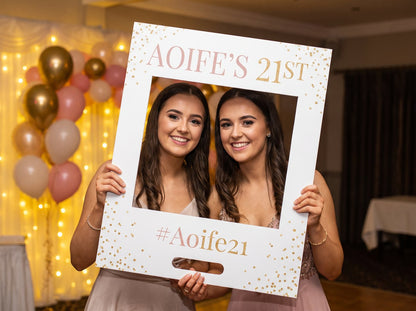 Two friends holding a personalised A1 foamex selfie frame for a 21st (example design)